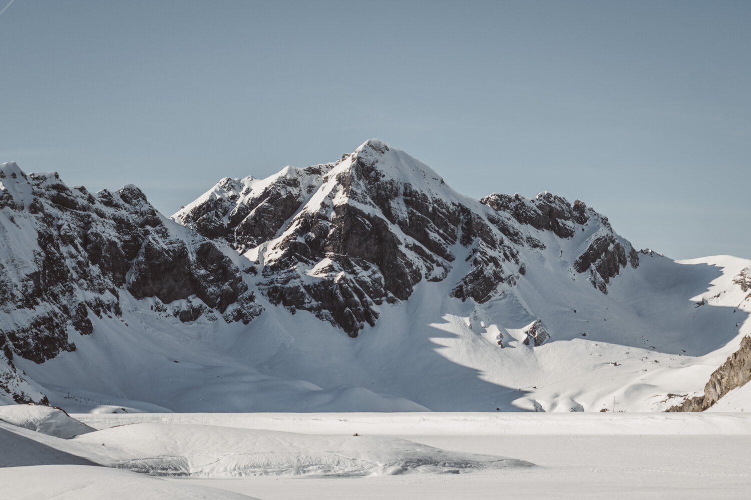 Rocky massif over a snowy plain