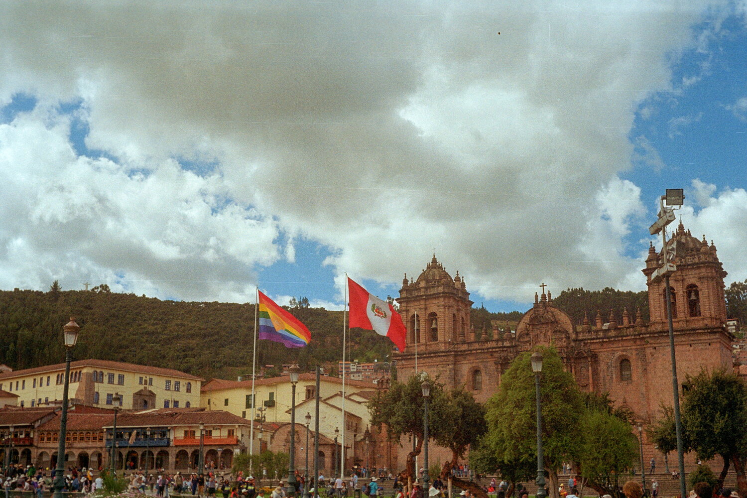 Flags and cathedral on the main square of Cusco