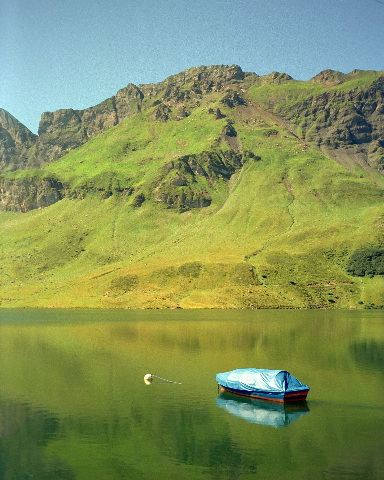 A covered boat on the still Melchsee