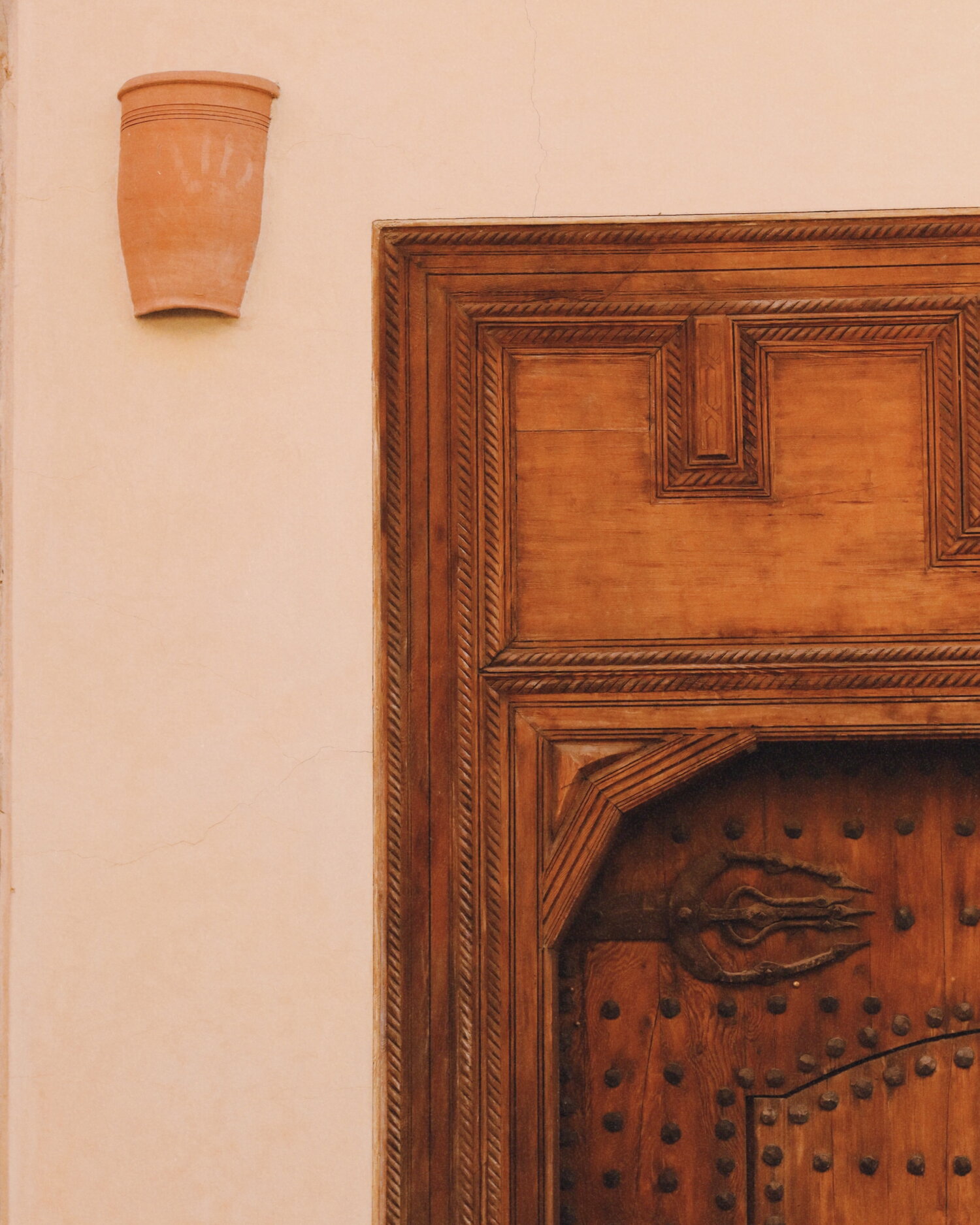 Carved doorway on a pink wall