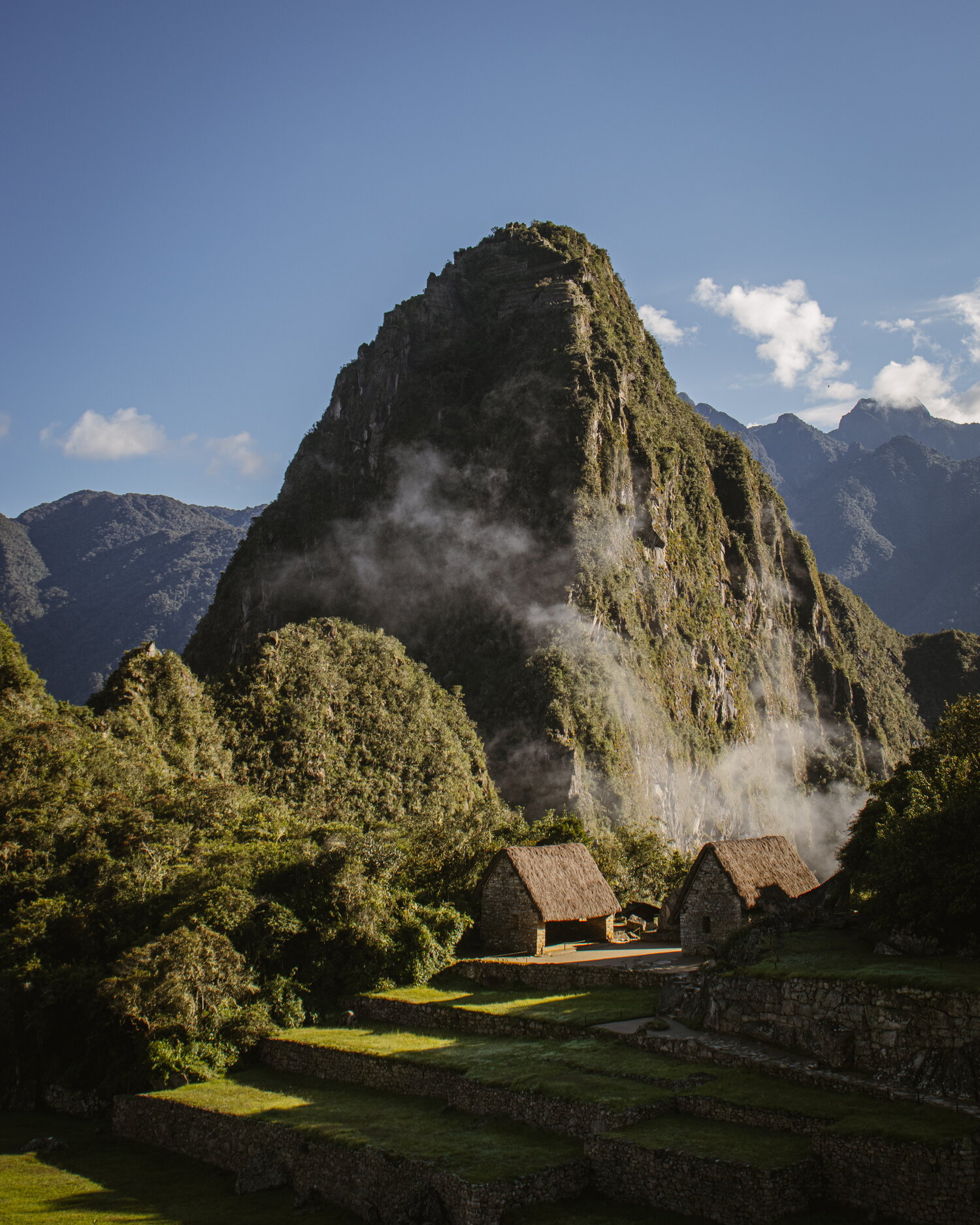 Machu Picchu terraces below a misty peak