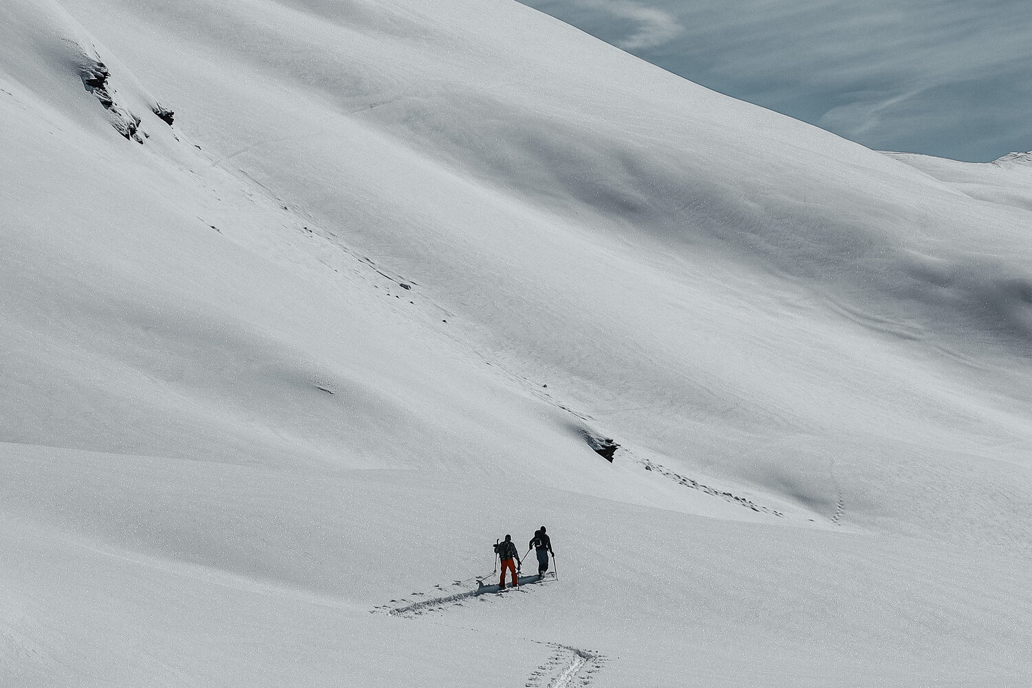 Two snowshoers on a vast untouched slope