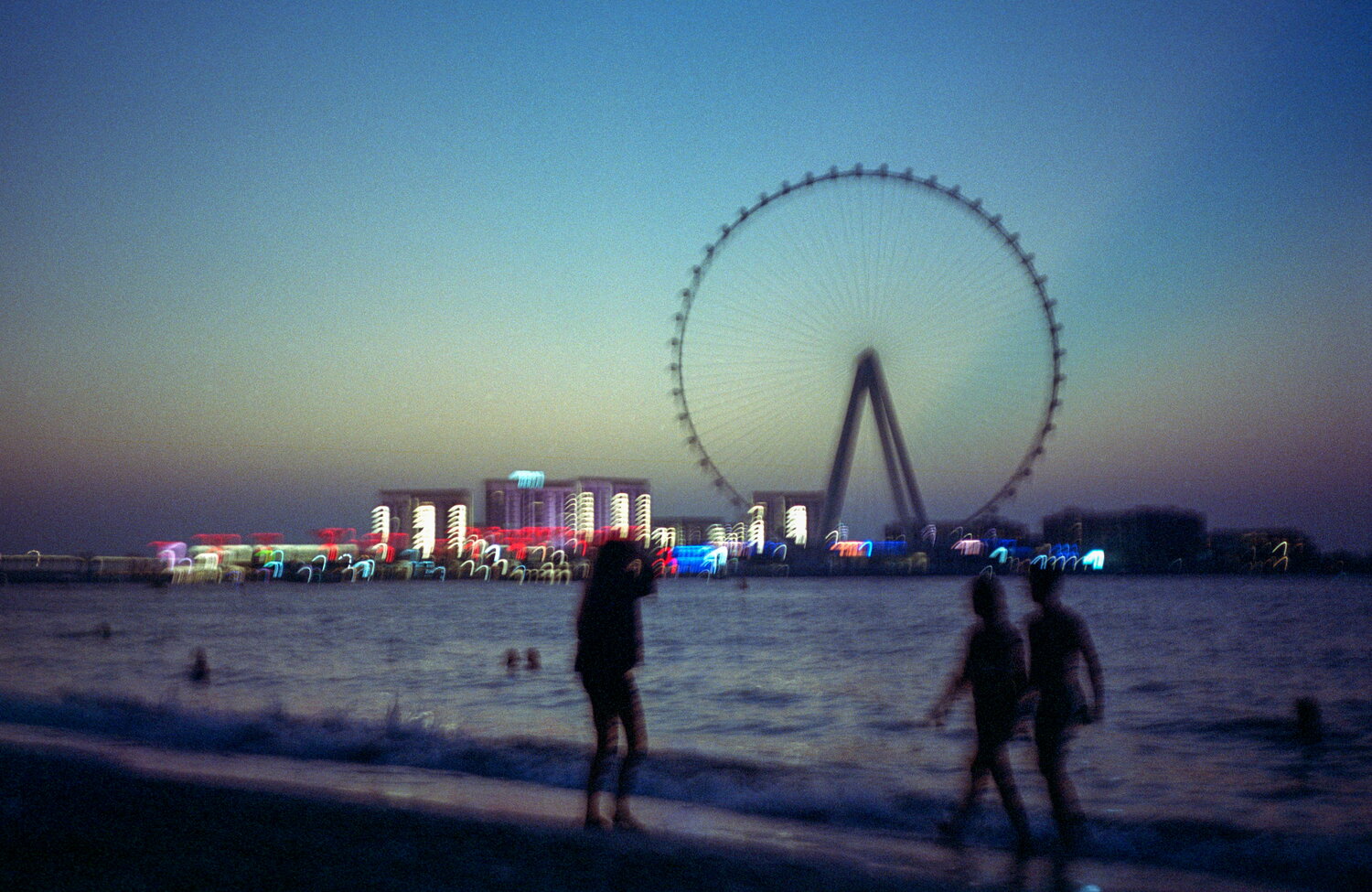 Dusk on a Dubai beach with a big wheel