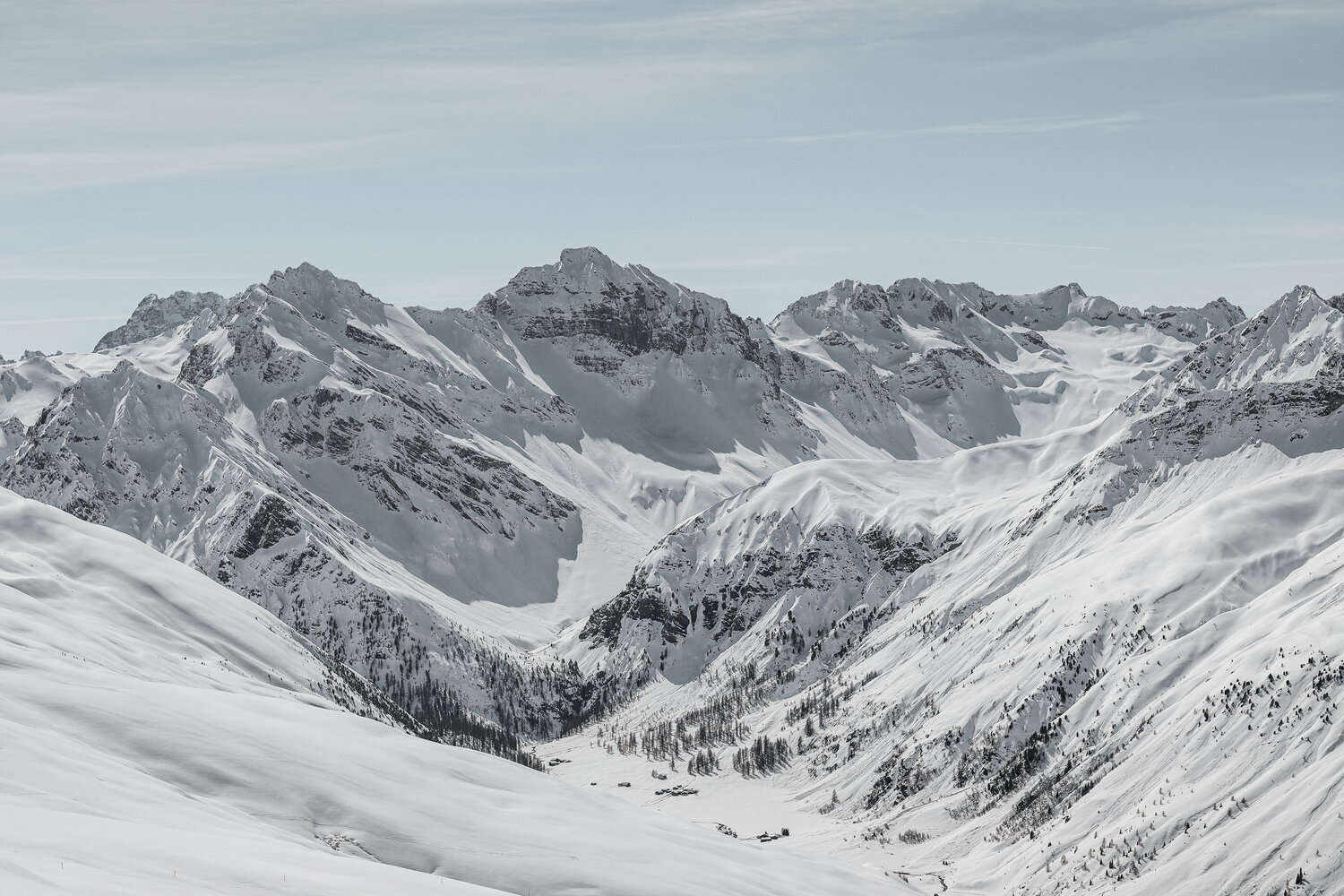 Snowbound alpine valley under rugged peaks